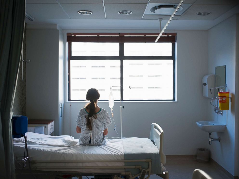 A patient sitting on a hospital bed is pictured in this undated stock photo.