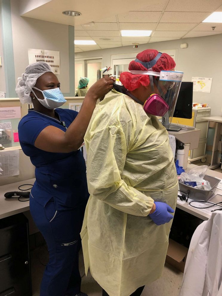 PHOTO: Hospital staff at Prince George Hospital Center help Dr. Elizabeth Clayborne, put on her personal protective equipment before treating Coronavirus patients in the Emergency Department.