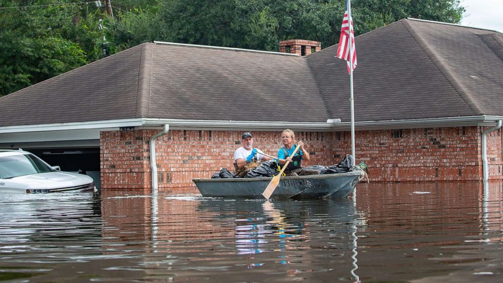 PHOTO: Jason and Susie Horn gather belongings from their home as water continues to rise along Interstate I-10 in Vidor, Texas, Sept. 20, 2019.