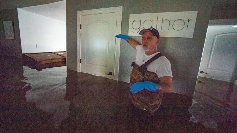 PHOTO: Jason Horn points to the level that his home was flooded by Harvey as water continues to rise along Interstate I-10 in Vidor, Texas, Sept. 20, 2019.