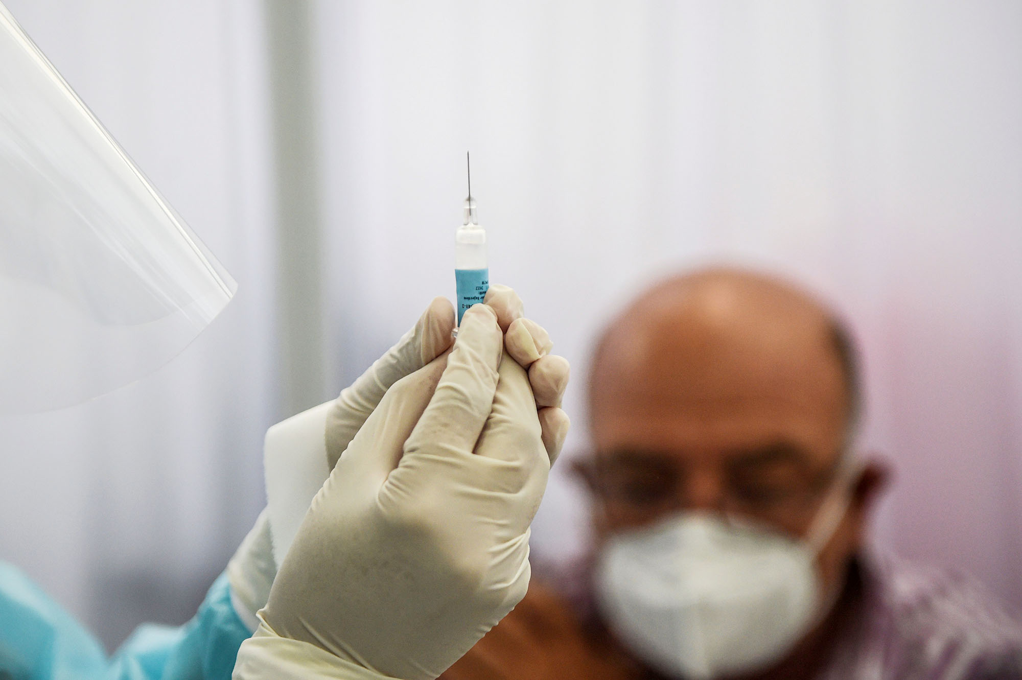 PHOTO: A health worker prepares a syringe to inoculate a volunteer with a COVID-19 vaccine  during its trial in Lima, Peru, Dec. 09, 2020.