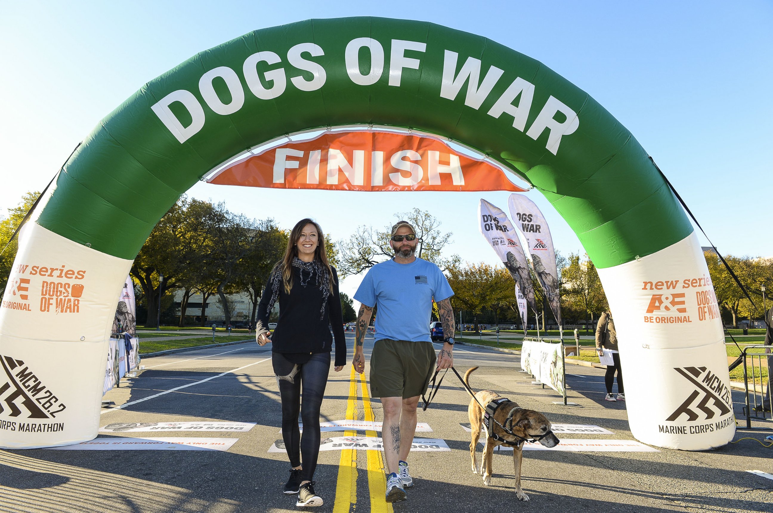 PHOTO: Lindsey Stanek and Jim Stanek, founders of Paws and Stripes and stars of A&E's "Dogs of War" walk during the 2K-9 Race, Oct. 26, 2014 in Washington. 