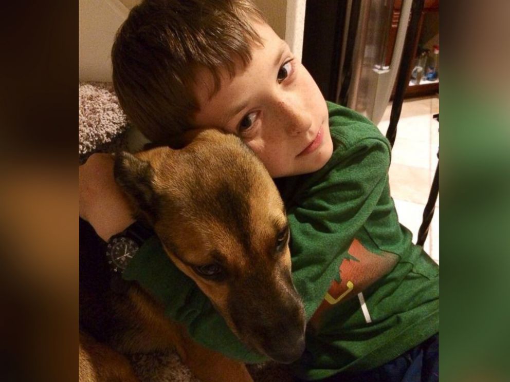 PHOTO: Alex Hermann hugs his dog, Spice, before the tragic events of being struck by lightning, Aug. 26, 2014.
