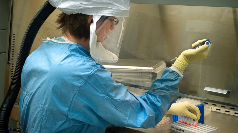This undated photograph shows a CDC scientist pipetting specimens in the Biosafety Level 4 Influenza Laboratory, Atlanta, GA. 
