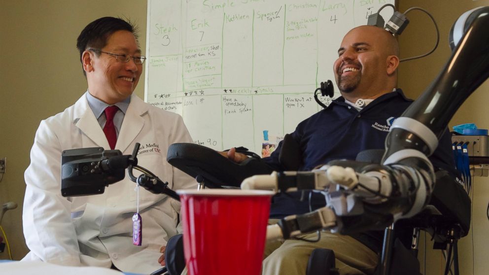 PHOTO: Dr. Charles Y. Liu, professor of neurological surgery, neurology, and biomedical engineering at USC, shares a laugh with patient Erik Sorto. 
