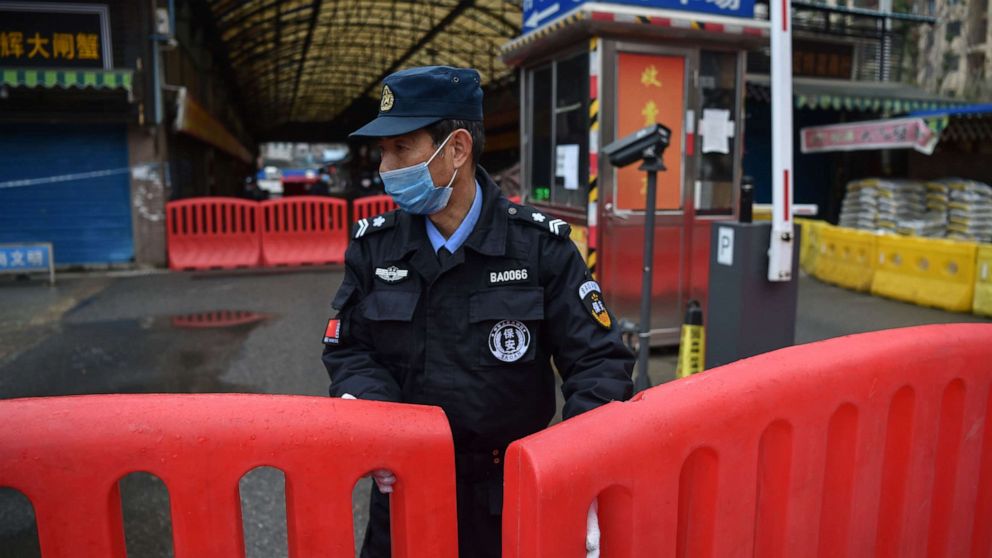 PHOTO: A police officer stands guard outside of Huanan Seafood Wholesale market in Wuhan on Jan. 24, 2020.