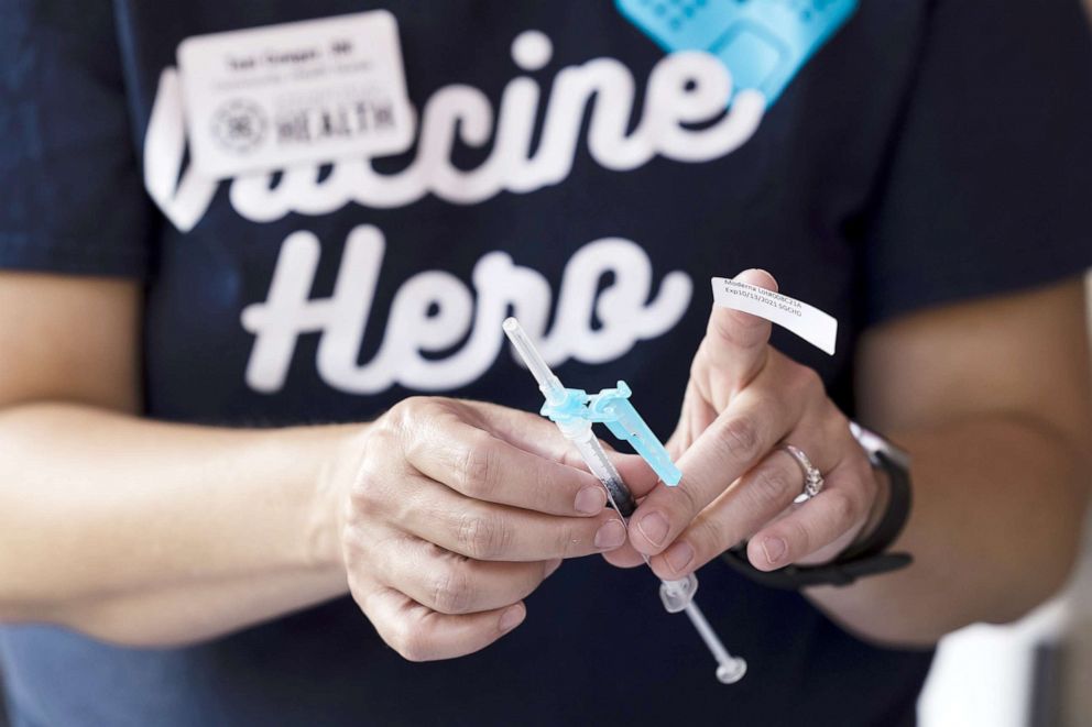 PHOTO: A healthcare worker prepares a dose of the Moderna Covid-19 vaccine at a pop up vaccination site in Springfield, Mo., Aug. 3, 2021.