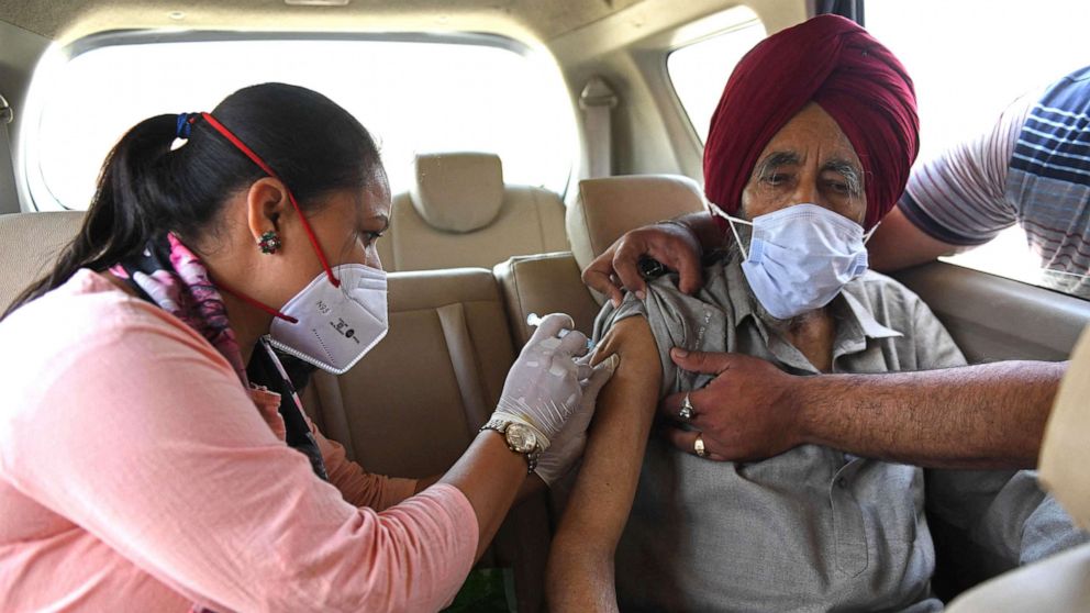 PHOTO: A health worker inoculates a man with a dose of the Covishield coronavirus vaccine on the outskirts of Amritsar, India, May 24, 2021.