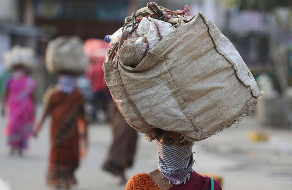 PHOTO: An Indian woman leaves after selling vegetables at a market in Hyderabad, India, March 28, 2020. 