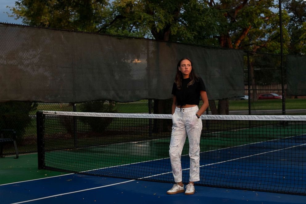 PHOTO: Izzy Benasso stands near the spot where she tore a meniscus in her knee while playing tennis with her dad in July 2019 at the Washington Park Tennis Club in Denver.