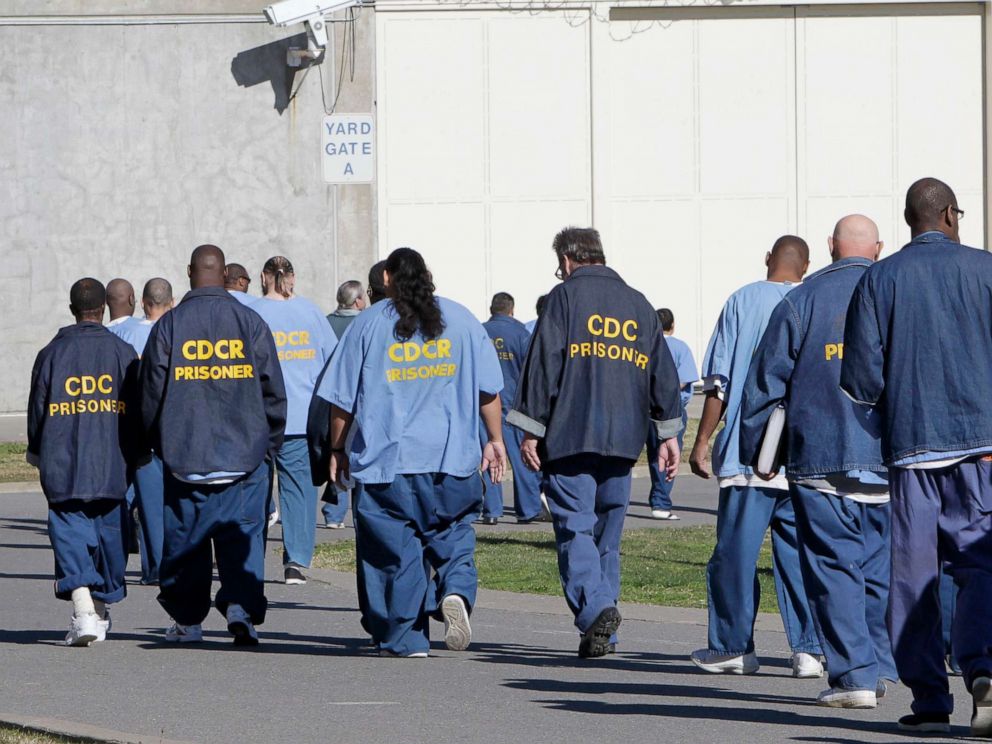 PHOTO: Inmates walk through the exercise yard at California State Prison Sacramento, near Folsom, Calif., Feb. 26, 2013.