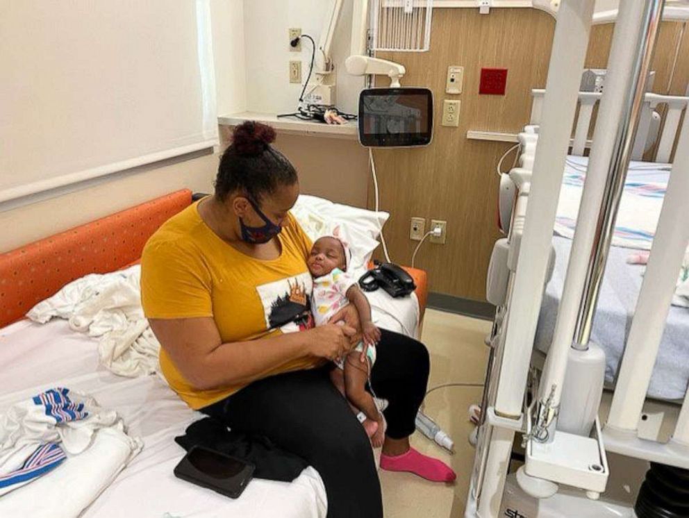 PHOTO: Jackie Kerby holds her baby daughter Enaeshya, who is hospitalized with COVID-19 at Dayton Children’s Hospital.