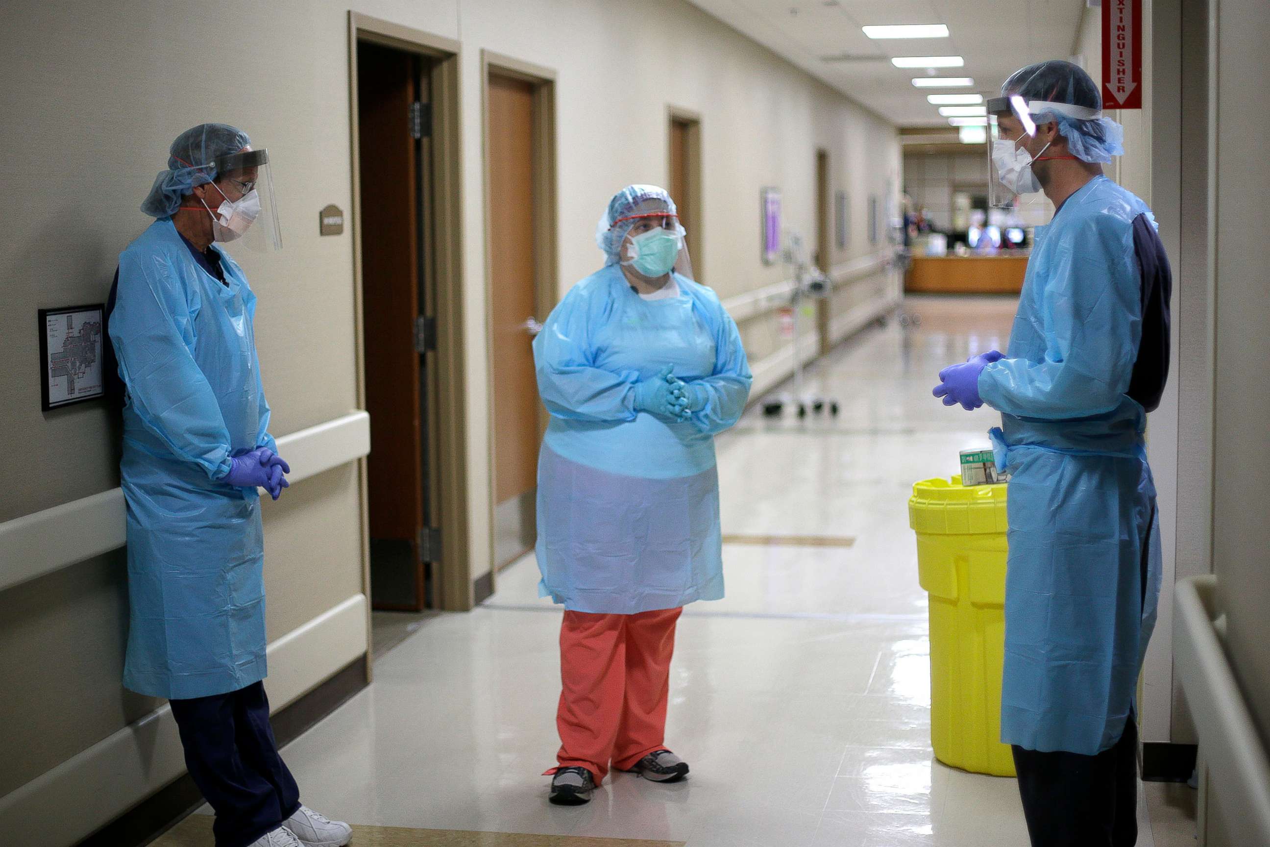 PHOTO: Hospital staff talk after checking on a COVID-19 patient Wednesday, May 20, 2020, at Kearny County Hospital in Lakin, Kan.