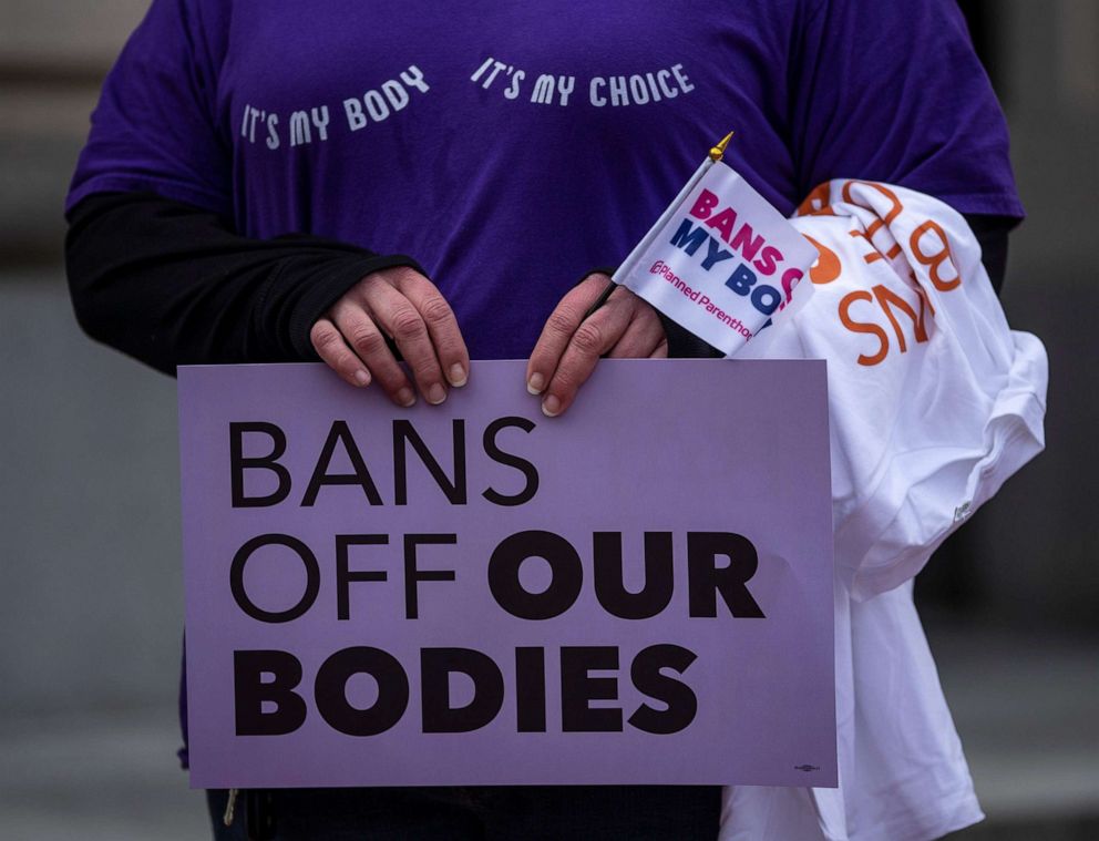 PHOTO: A protester holds a sign in front of the Kentucky State Capitol in Frankfort, Ky., March 29, 2022.