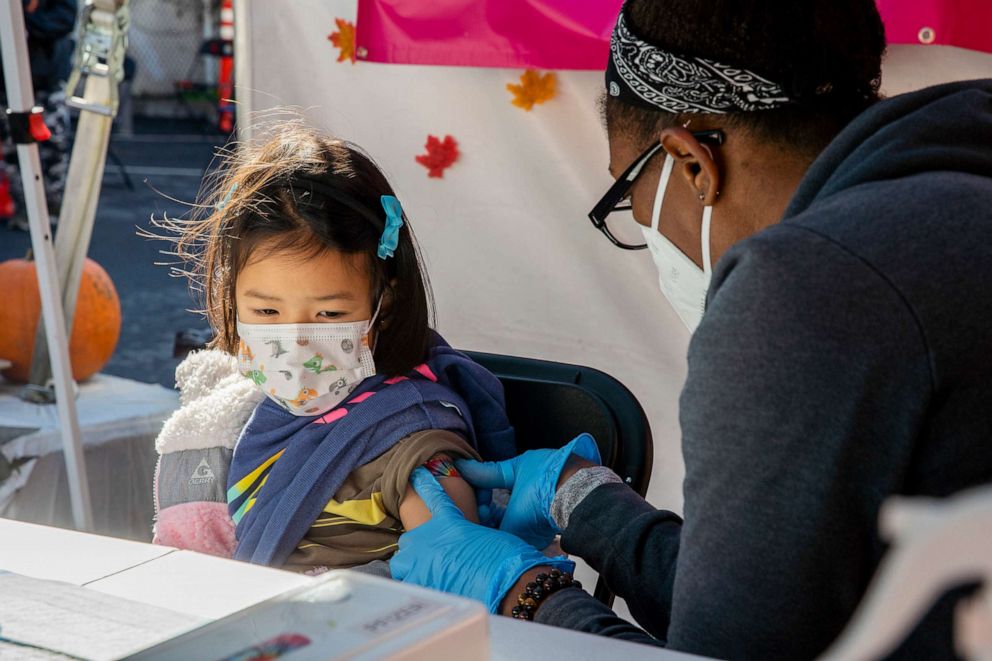 PHOTO: Six-year-old Calista B. at her second appointment for the Pfizer COVID-19 vaccine administered by Alexandria Morrison, Dec. 30, 2021, in San Francisco.