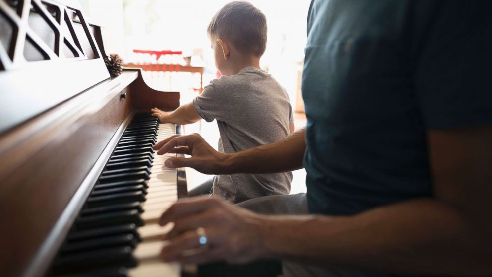 A child is seen pictured playing a piano seen this undated stock photo.