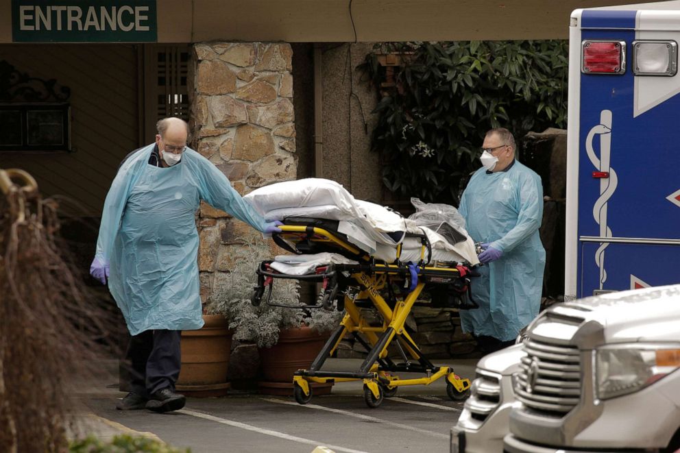 Medics transport a person on a stretcher into an ambulance at the Life Care Center of Kirkland, a long-term care facility linked to several confirmed coronavirus cases, in Kirkland, Washington, March 3, 2020.