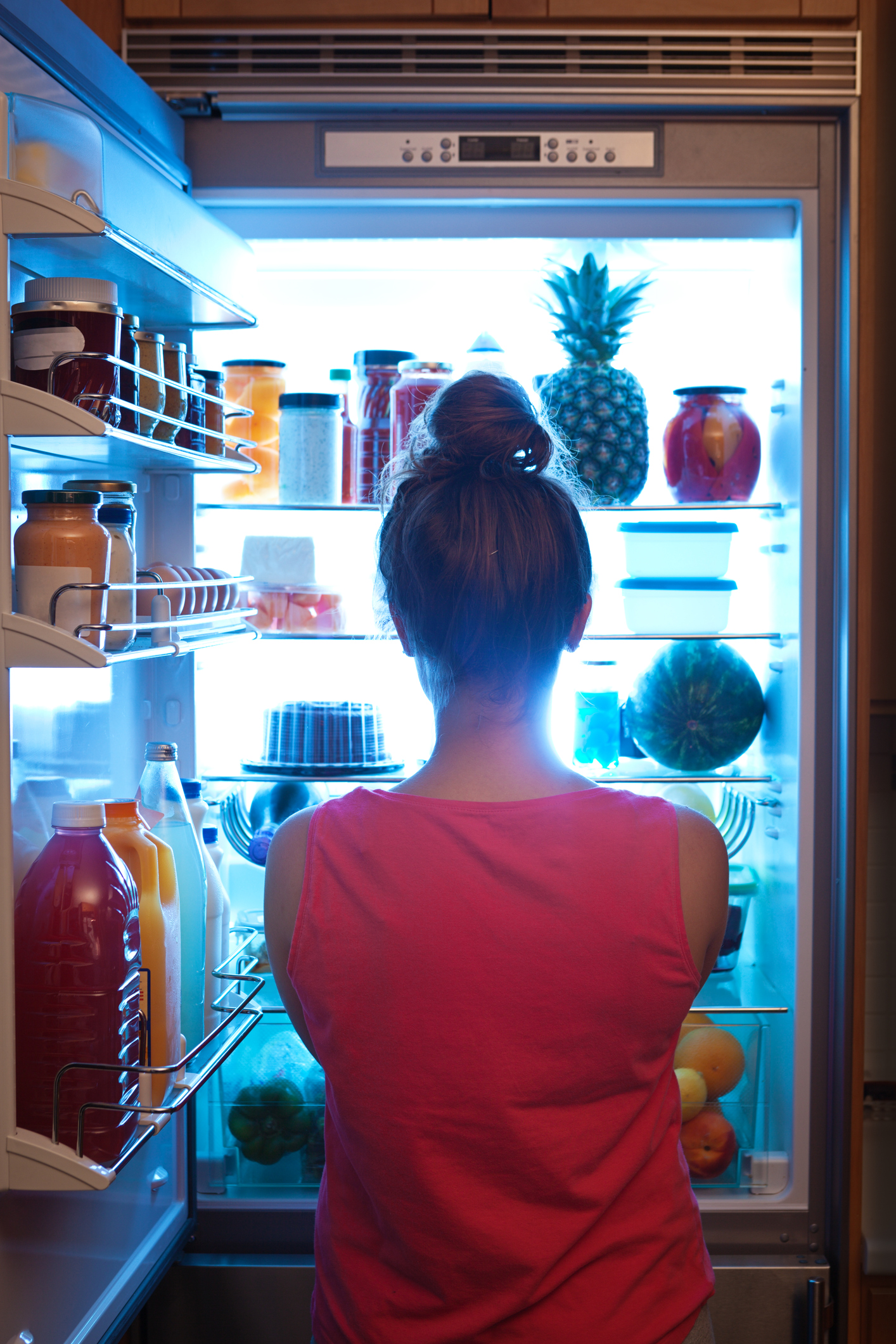 PHOTO: A woman is pictured standing in front of the open refrigerator late at night in this undated stock photo.