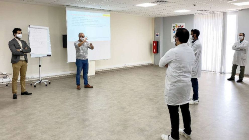 PHOTO: Employees have a socially distanced meeting and COVID-19 training at Lear, in Rabat, Morocco, April 13, 2020.