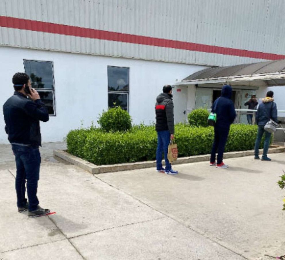 PHOTO: Employees stand outside of the Lear plant waiting for their daily health screenings, in Rabat, Morocco, April 13, 2020.
