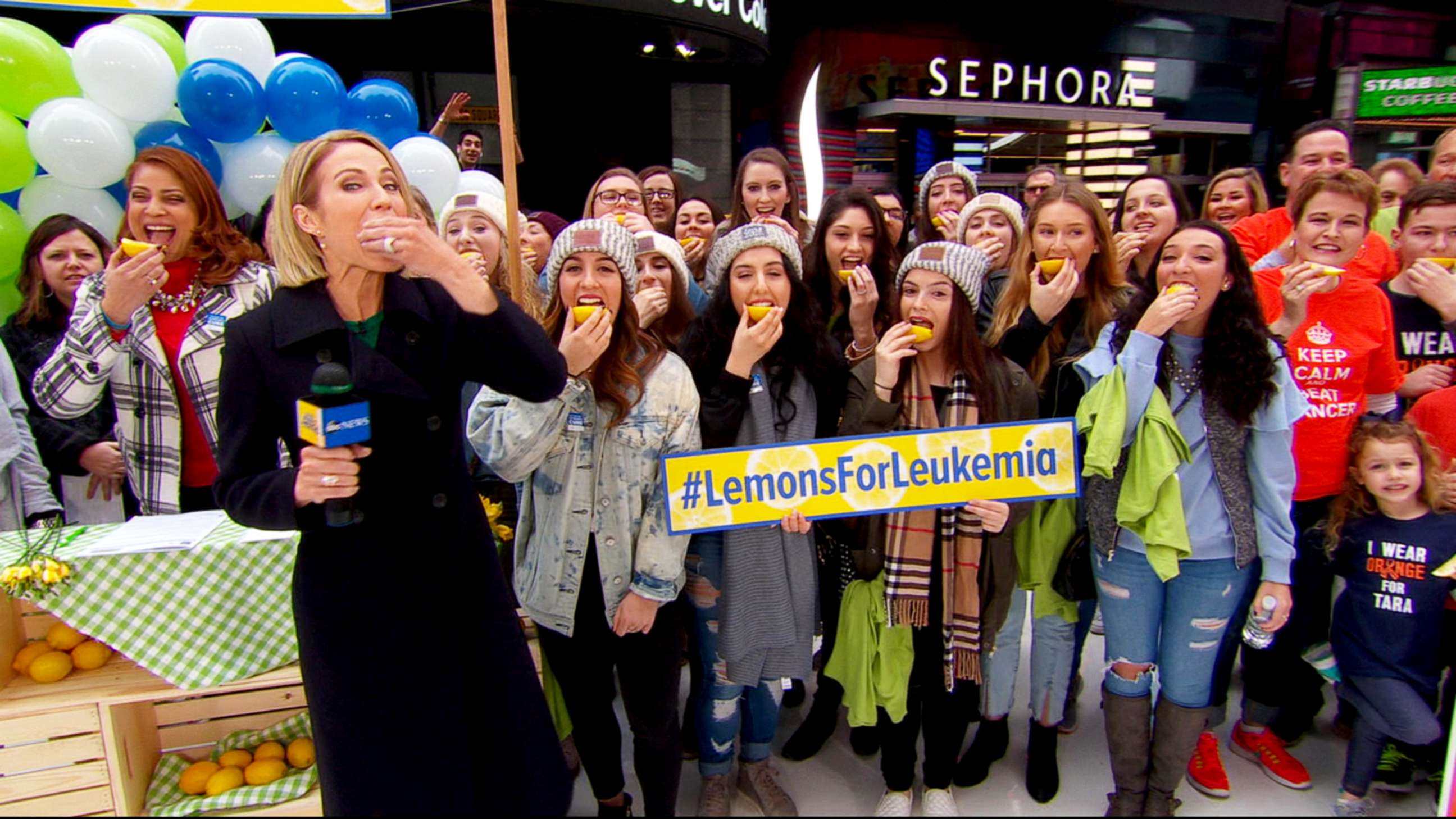 PHOTO: People outside the "Good Morning America" studio in Times Square take part in the "Lemons for Leukemia Challenge," a social media campaign to raise awareness about bone marrow donation