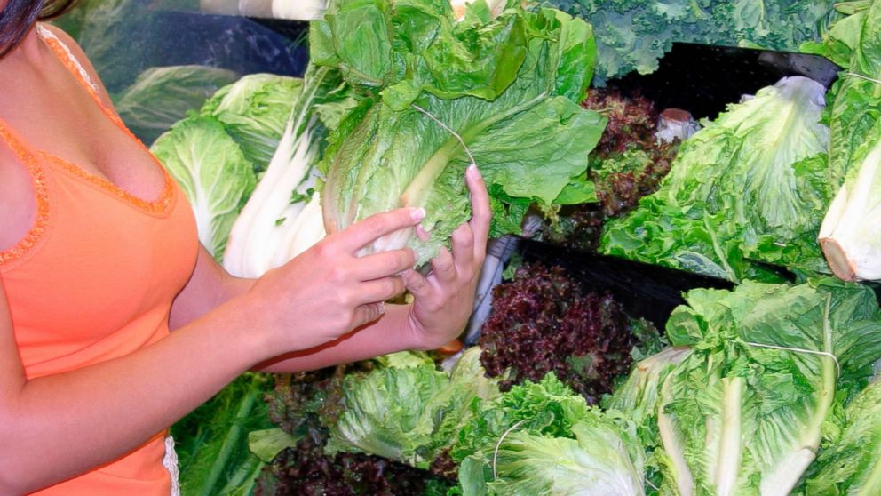 PHOTO: A woman is pictured holding romaine lettuce at a store.