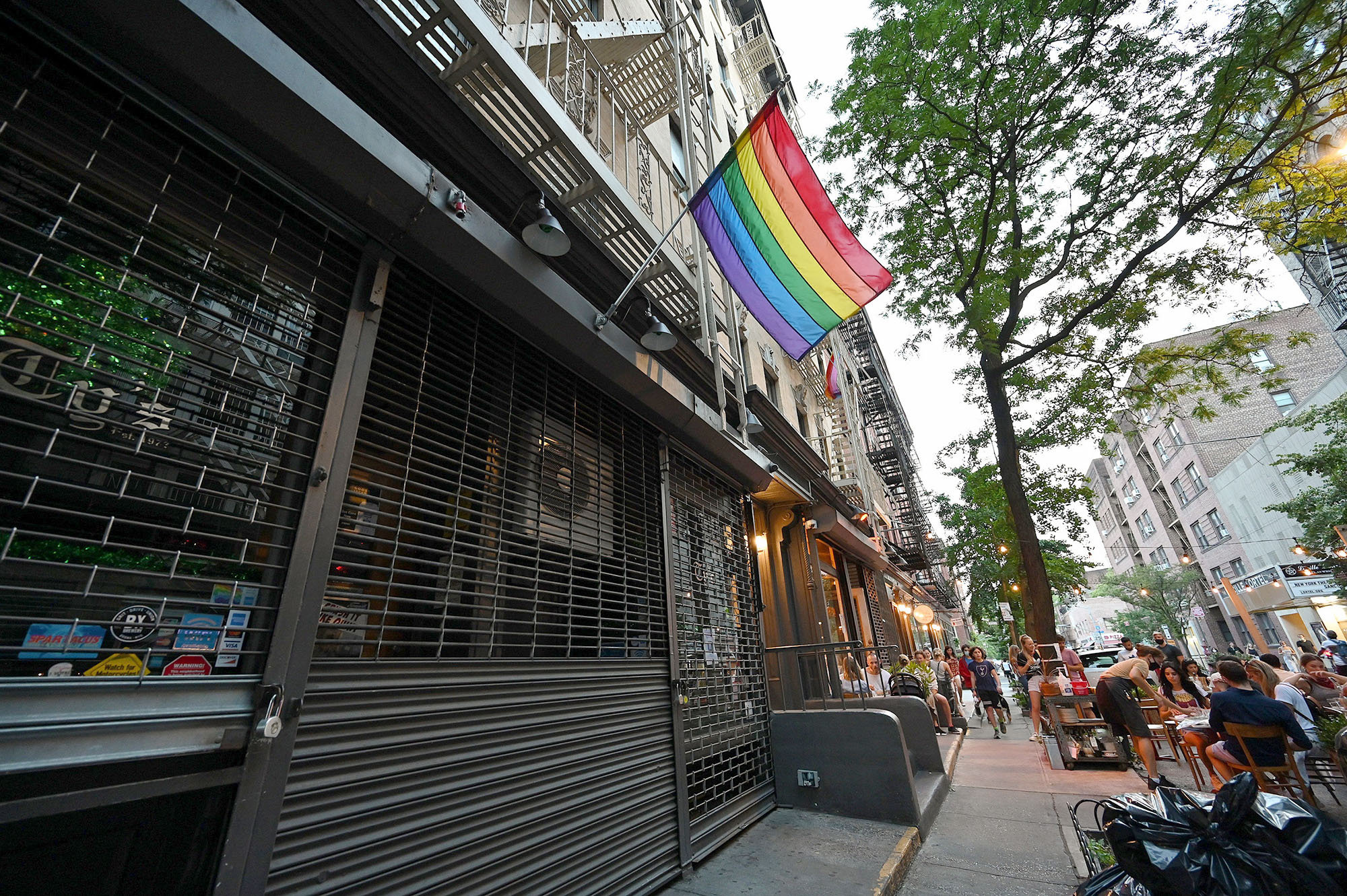PHOTO: A Pride flag hangs outside a temporarily closed bars and storefronts on Christopher Street in New York, June 22, 2020.