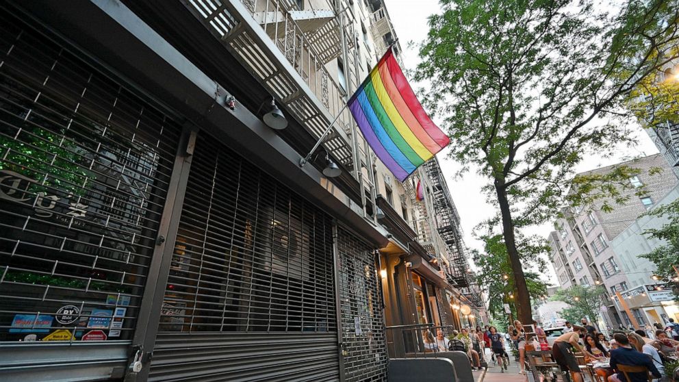 PHOTO: A Pride flag hangs outside a temporarily closed bars and storefronts on Christopher Street in New York, June 22, 2020.