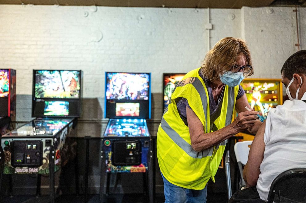 PHOTO: Alan Drees receives their Moderna COVID-19 vaccine during a mobile vaccination mission at Mile Wide Beer Co. on June 4, 2021 in Louisville, Ky. in partnership with Dept. of Public Health and Wellness, Kentucky Nurses Association, and Queer Kentucky