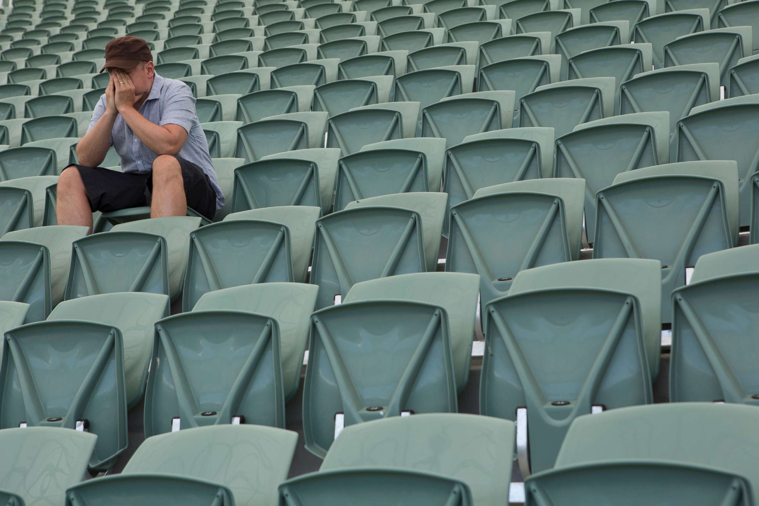 PHOTO: An undated stock photo shows a man siting in an empty stadium. 