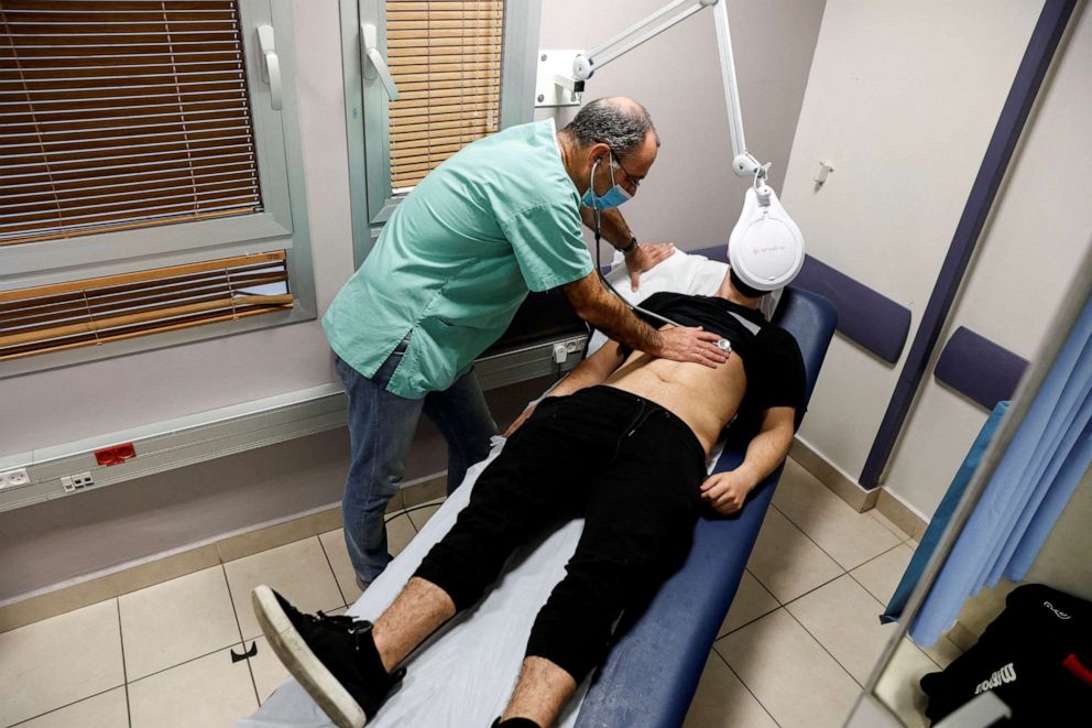 FILE PHOTO: A patient suffering from Long COVID is examined in the post-coronavirus disease (COVID-19) clinic of Ichilov Hospital in Tel Aviv, Israel, February 21, 2022. Picture taken February 21, 2022. 