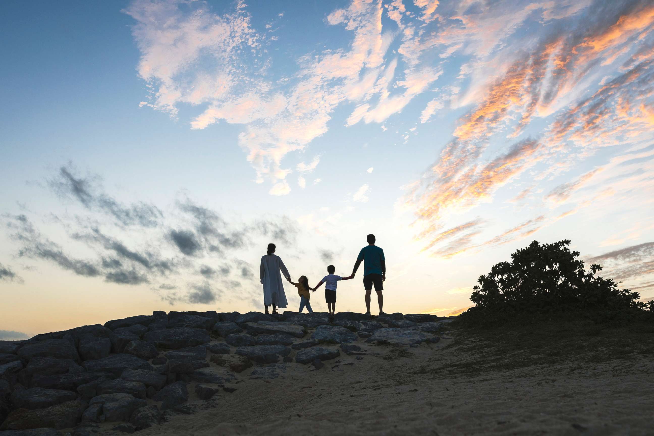 PHOTO: A family plays in the beach at sunset in Okinawa, Japan, in a stock image. 