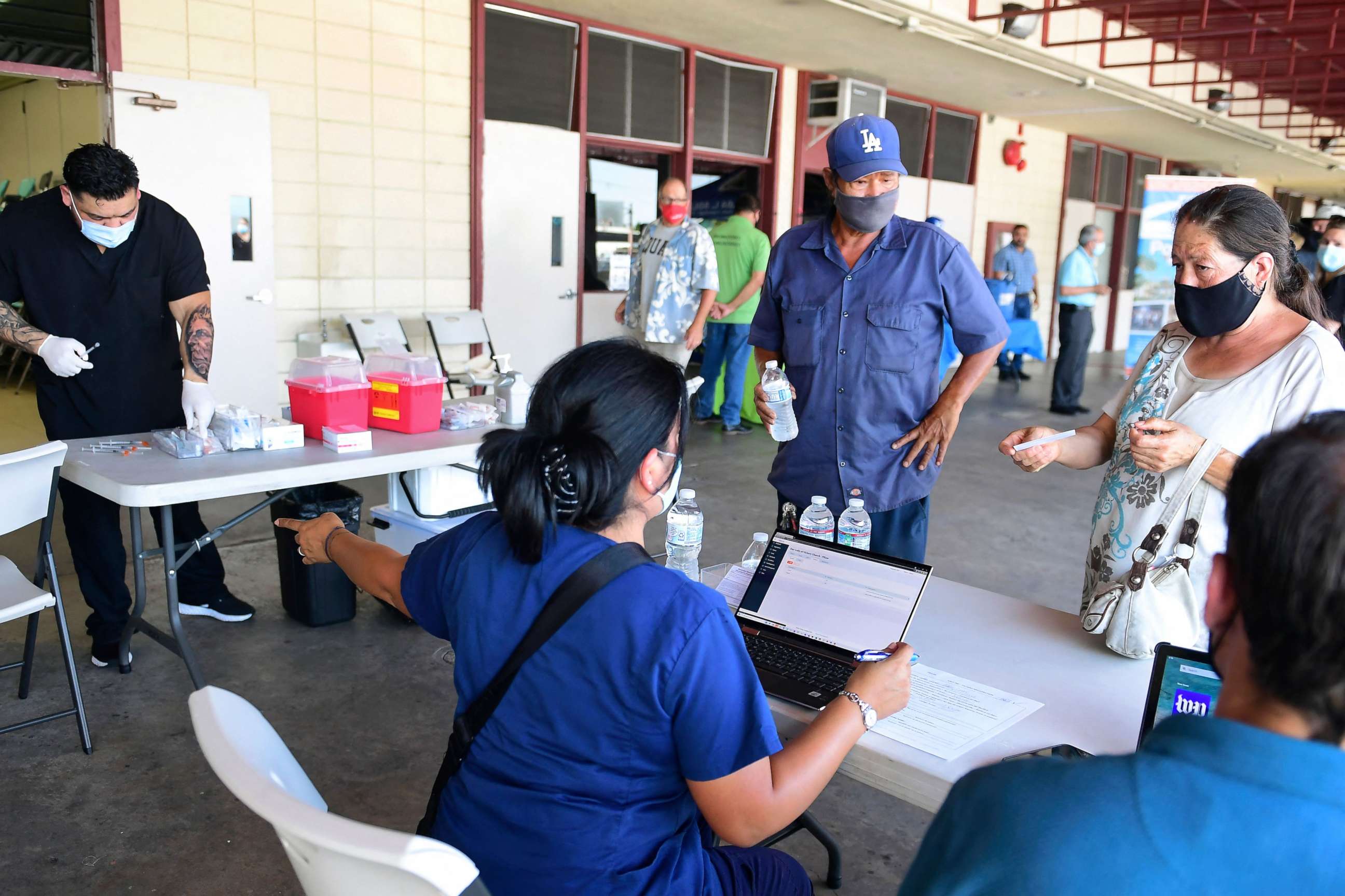 PHOTO: People check in for their COVID-19 vaccine at a mobile clinic in an East Los Angeles neighborhood, July 9, 2021, in Los Angeles.