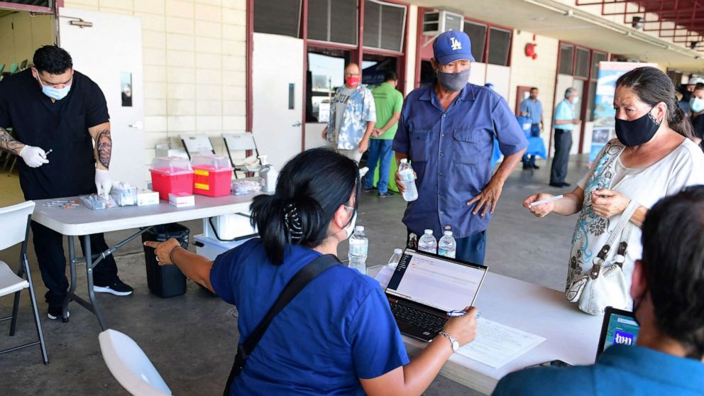 PHOTO: People check in for their COVID-19 vaccine at a mobile clinic in an East Los Angeles neighborhood, July 9, 2021, in Los Angeles.