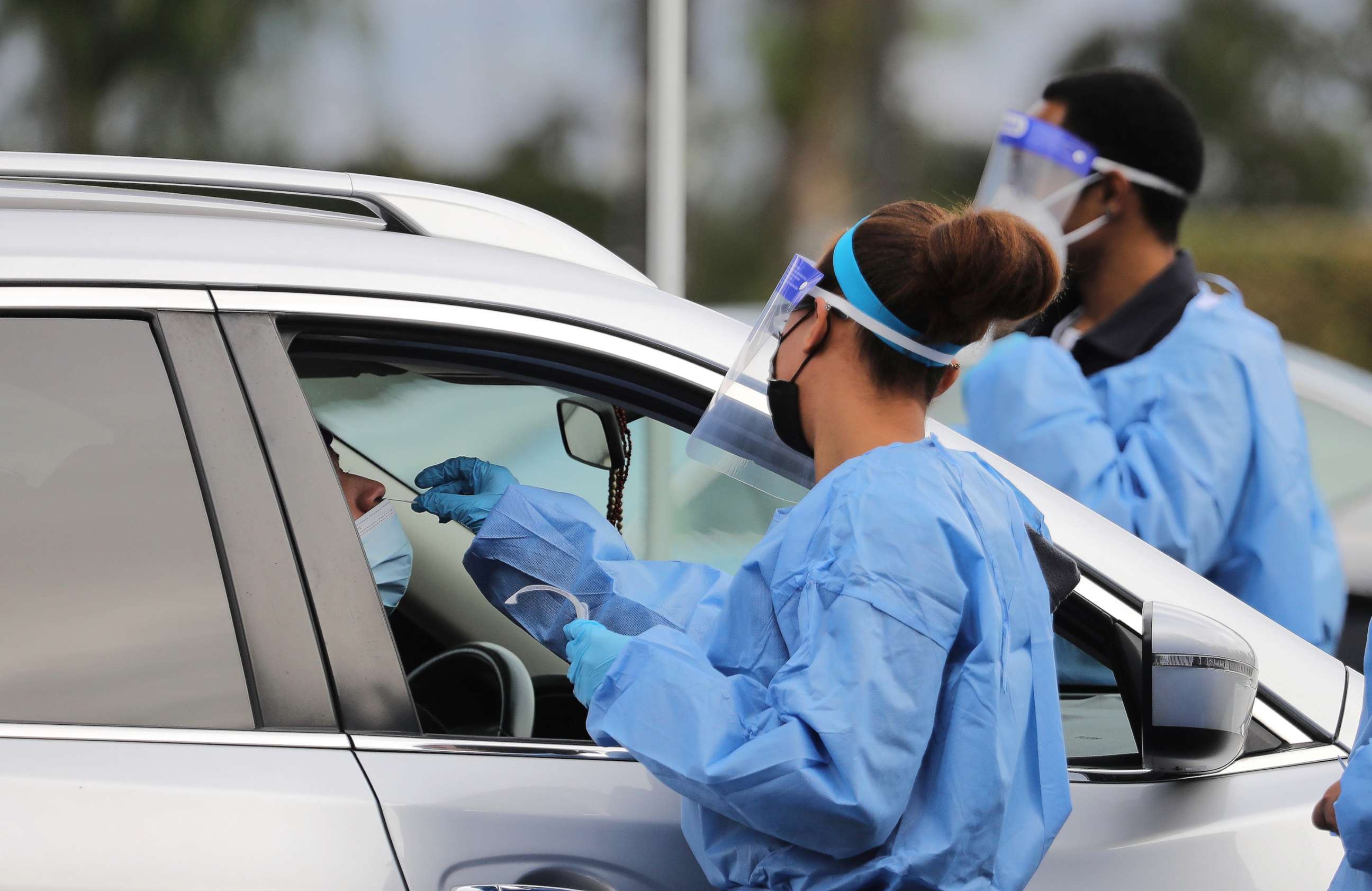 PHOTO: A medical worker collects a swab sample at a COVID-19 drive-through testing site in Los Angeles, Jan. 10, 2022. 