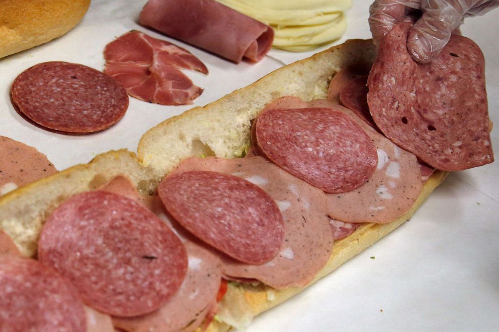 PHOTO: In this June 5, 2014, file photo, a man makes a submarine sandwich with mortadella, cooked salami, ham, Genoa salami and sweet capicola at a delicatessen in Massachusetts.