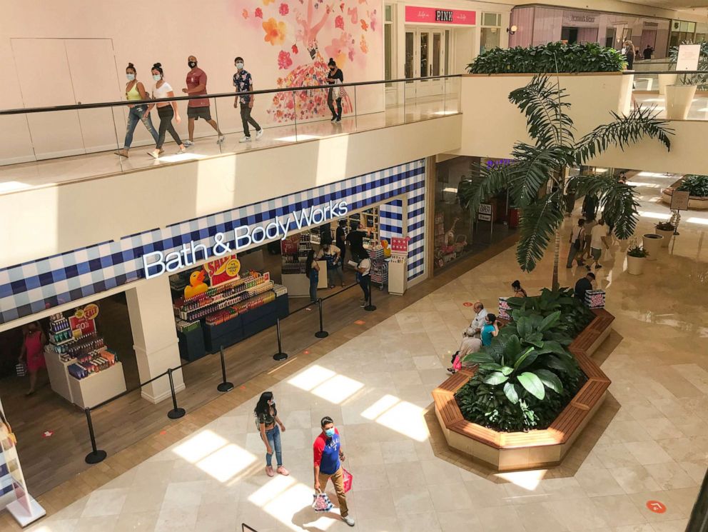 PHOTO: Shoppers wear masks while shopping at South Coast Plaza Monday, July 13, 2020 in Costa Mesa, Calif.