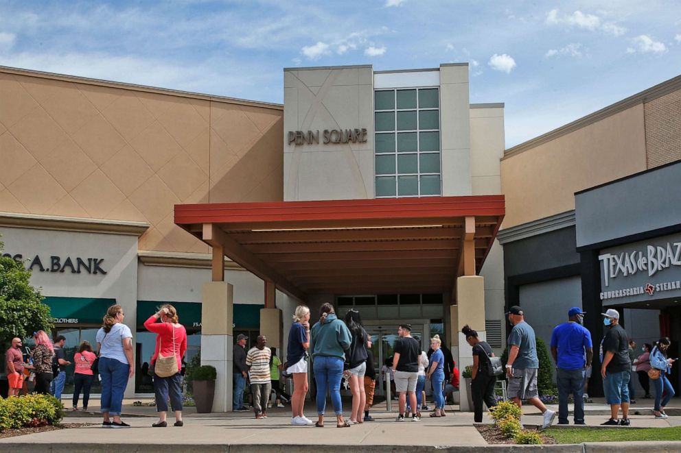 PHOTO: People wait outside Penn Square Mall for the doors to open Friday, May 1, 2020, in Oklahoma City, as the mall reopens. The mall has been closed since mid-March due to coronavirus concerns. 