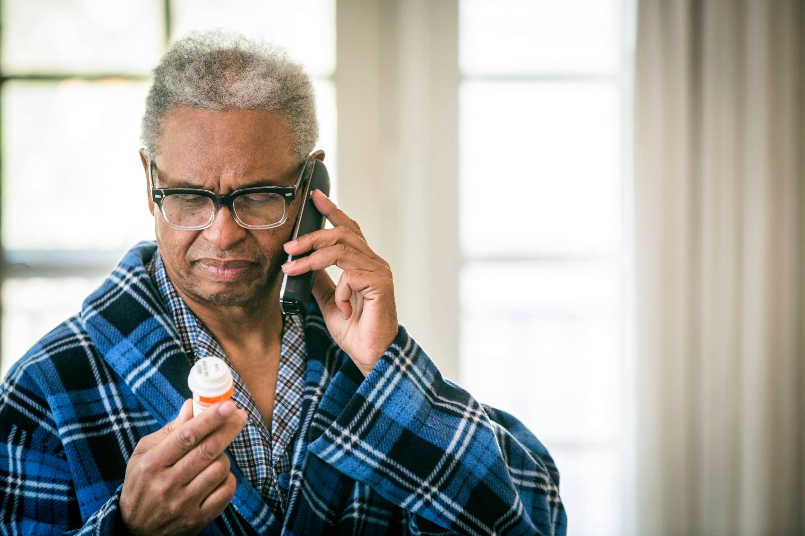 PHOTO: A man refills his prescription by phone in this stock photo.