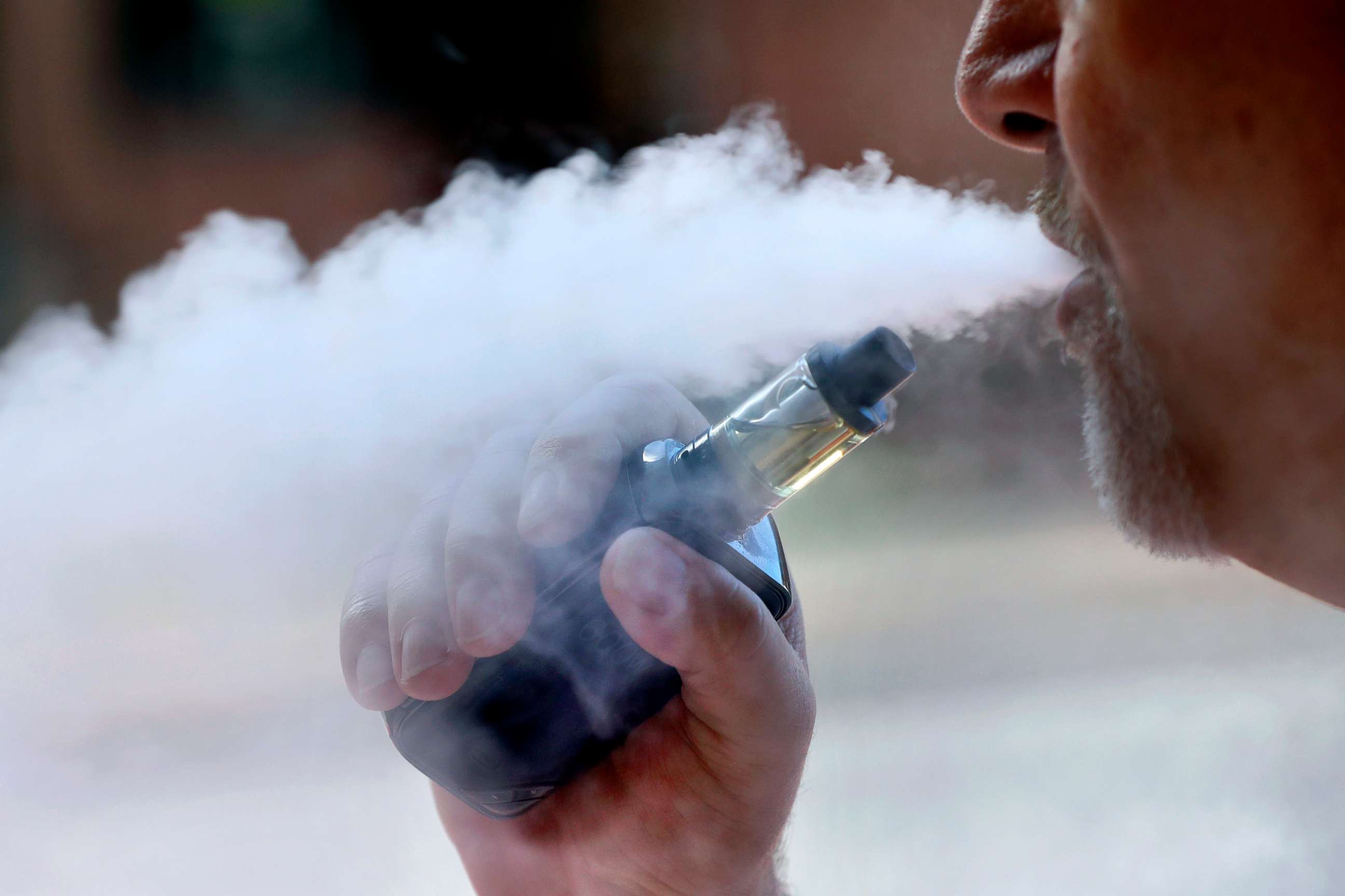 PHOTO: In this Aug. 28, 2019, file photo, a man exhales while smoking an e-cigarette in Portland, Maine. 