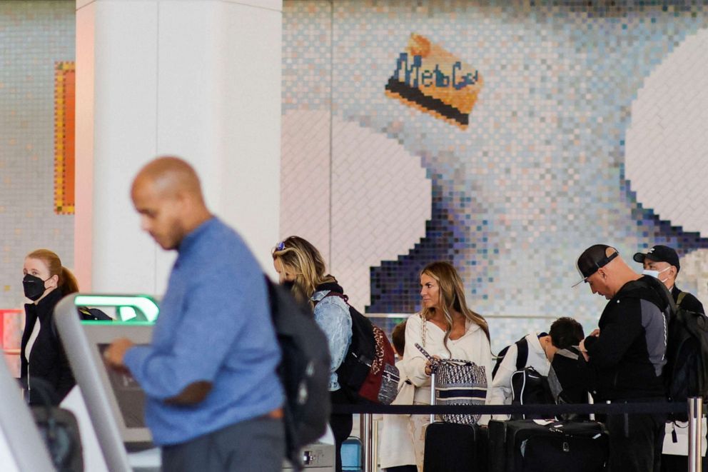 PHOTO: People arrive to the counter for check-in at La Guardia Airport after the Biden administration announced it would no longer enforce a U.S. COVID-19 mask mandate on public transportation, in New York, April 19, 2022.