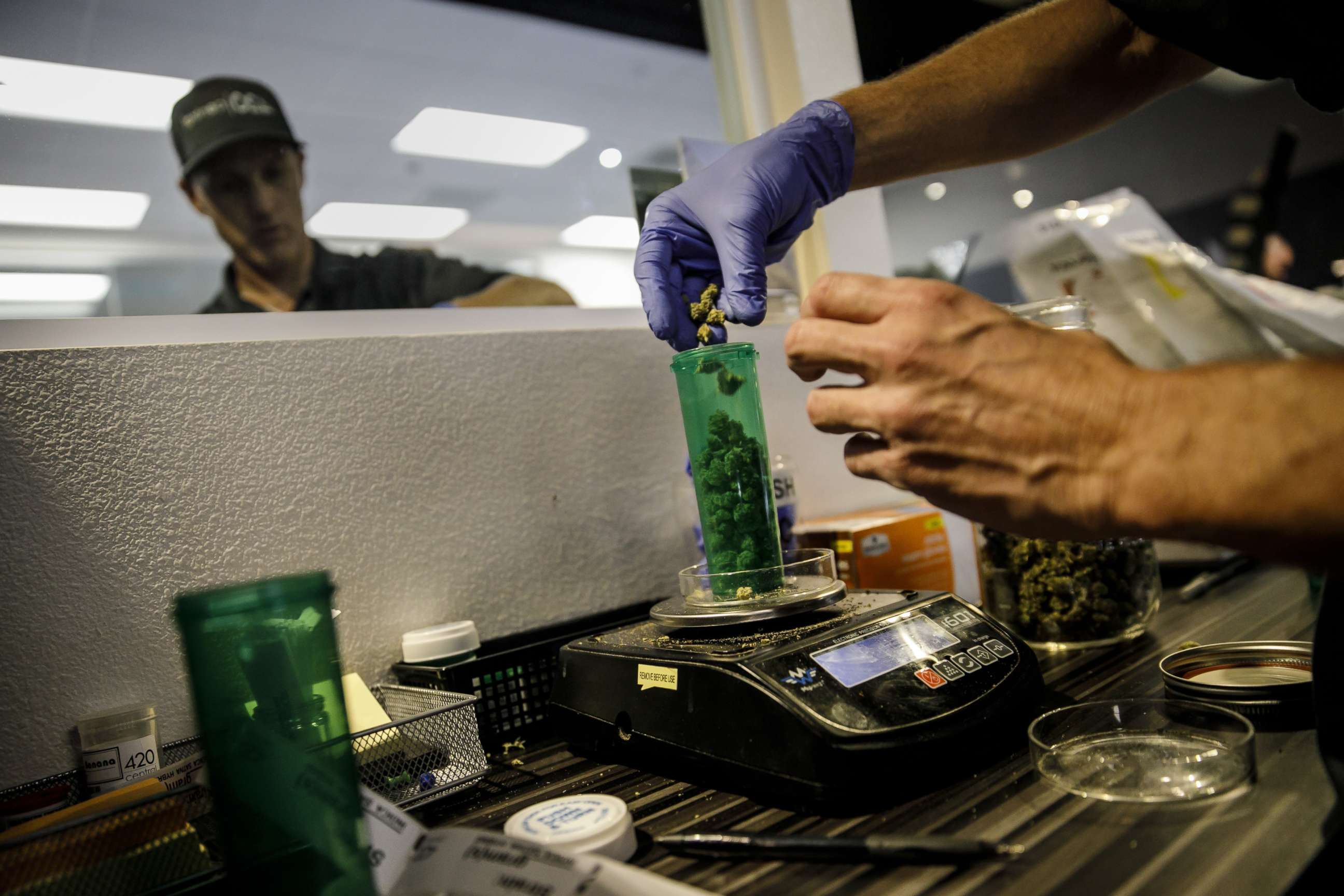 PHOTO: An employee dispenses a customer's order at a Medical Marijuana facility, in Santa Ana, Calif., Jan. 1, 2018. 