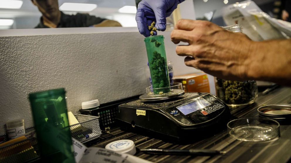 PHOTO: An employee dispenses a customer's order at a Medical Marijuana facility, in Santa Ana, Calif., Jan. 1, 2018.