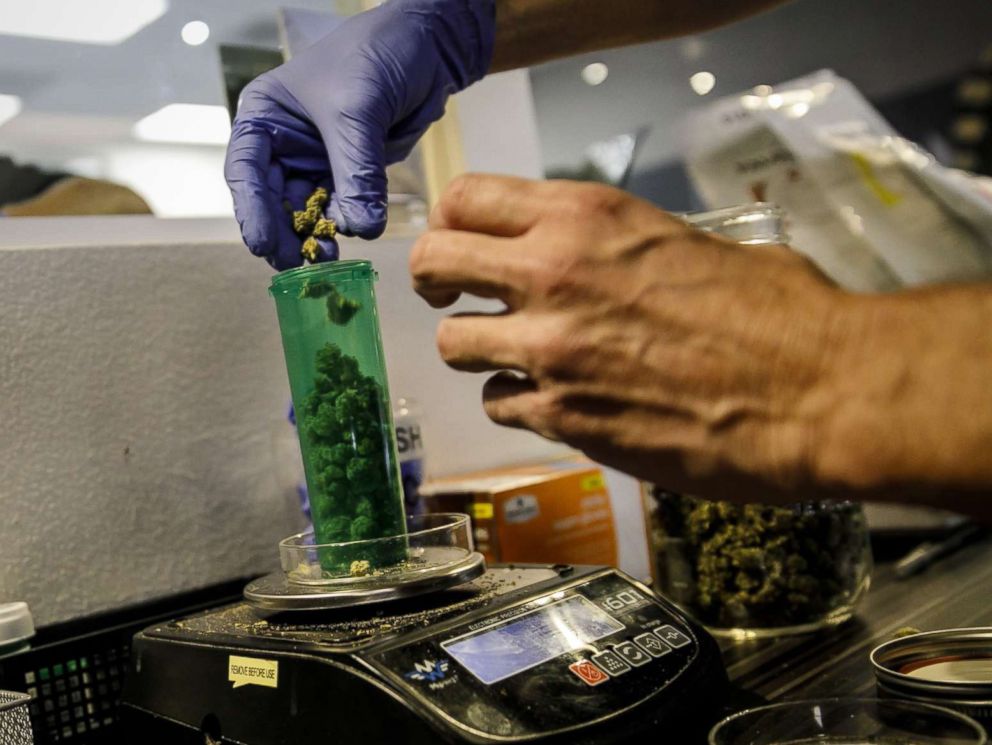 PHOTO: An employee dispenses a customers order at a Medical Marijuana facility, in Santa Ana, Calif., Jan. 1, 2018. 