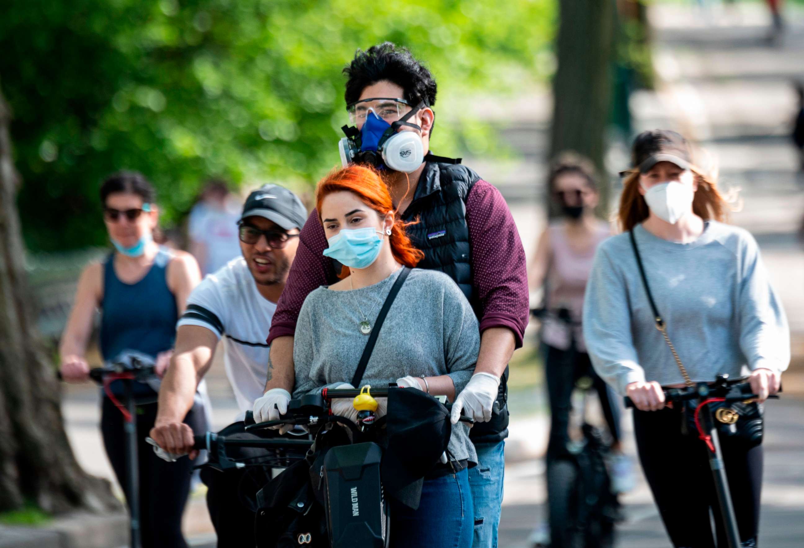 PHOTO: People wearing masks ride a scooter in Central Park on May 16, 2020 in New York City, amid the coronavirus pandemic.