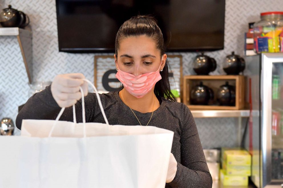 PHOTO: Marlboro Diner owner Kara Petrou wears a mask preparing Passover takeout meals for pickup on April 08, 2020 in Marlboro, New Jersey. 