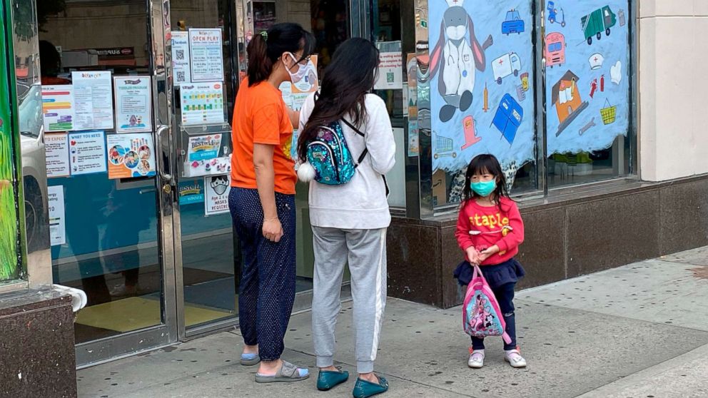 PHOTO: A parent picks up their child at daycare in Queens, N.Y., June 1, 2021.