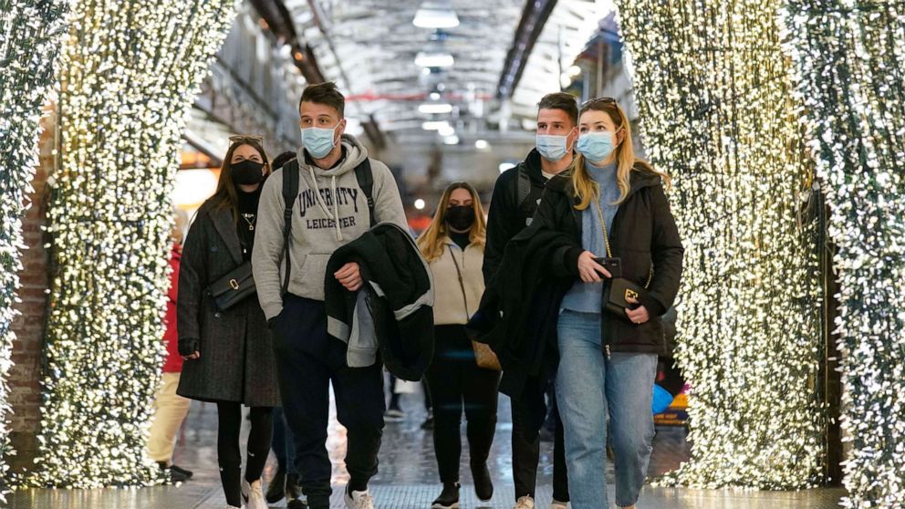 PHOTO: People wear masks while walking through an indoor shopping area in New York, Feb. 9, 2022.