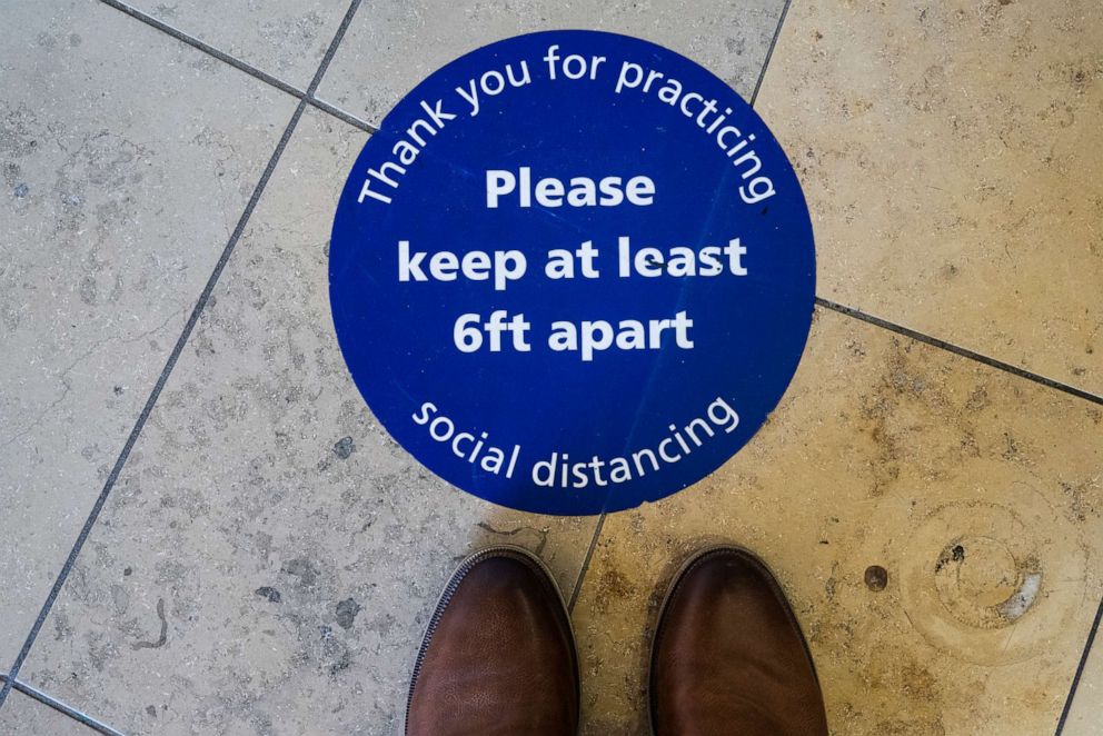 PHOTO: Social distancing signage marks the floor in Orange, Calif., April 14, 2022.