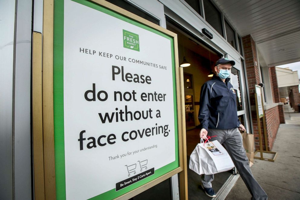 PHOTO: A sign outside the Fresh Market supermarket in Smithtown, New York asks customers not to enter without a face covering due to COVID-19 concerns on April 18, 2020.